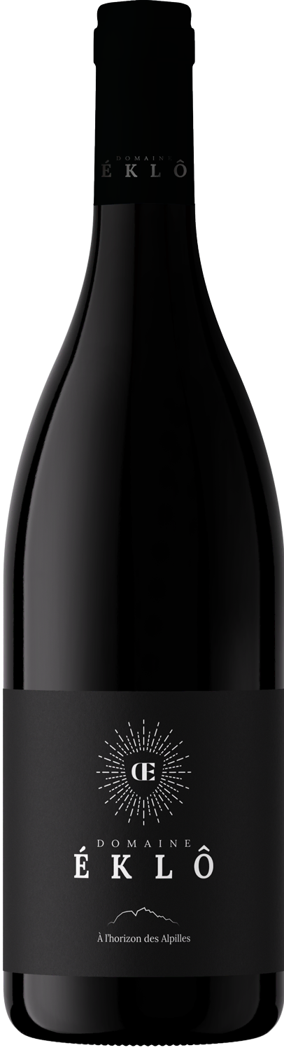 Bottle of Domaine Éklô wine with a black label featuring a radiant emblem and text saying 'À l'horizon des Alpilles.'