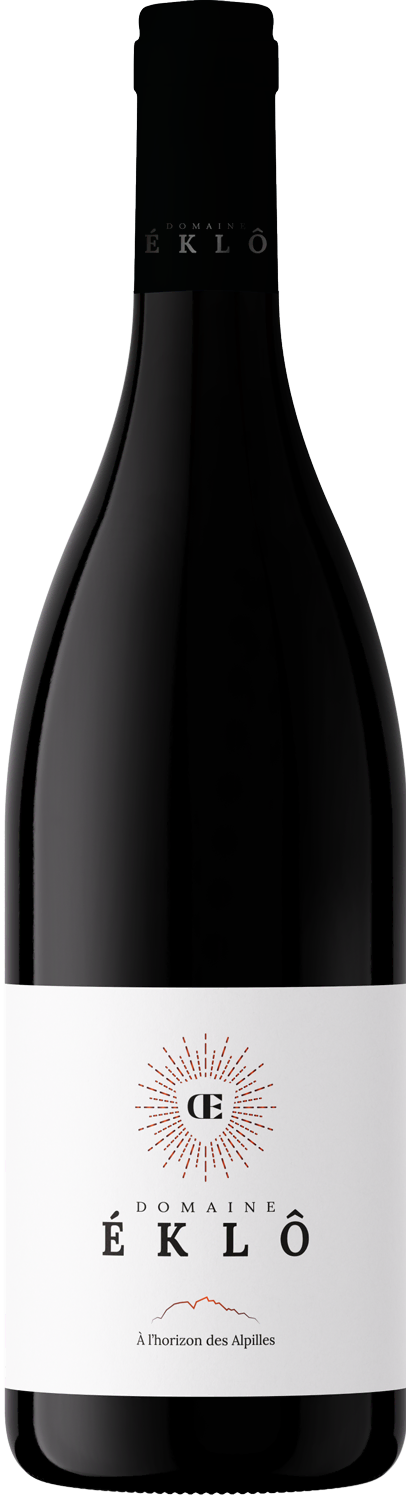 Bottle of Domaine Éklô red wine with white label featuring a radiant emblem and text 'À l’horizon des Alpilles.'